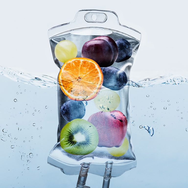 Fruit Slices In Saline Bag Dipped In Water Against Background